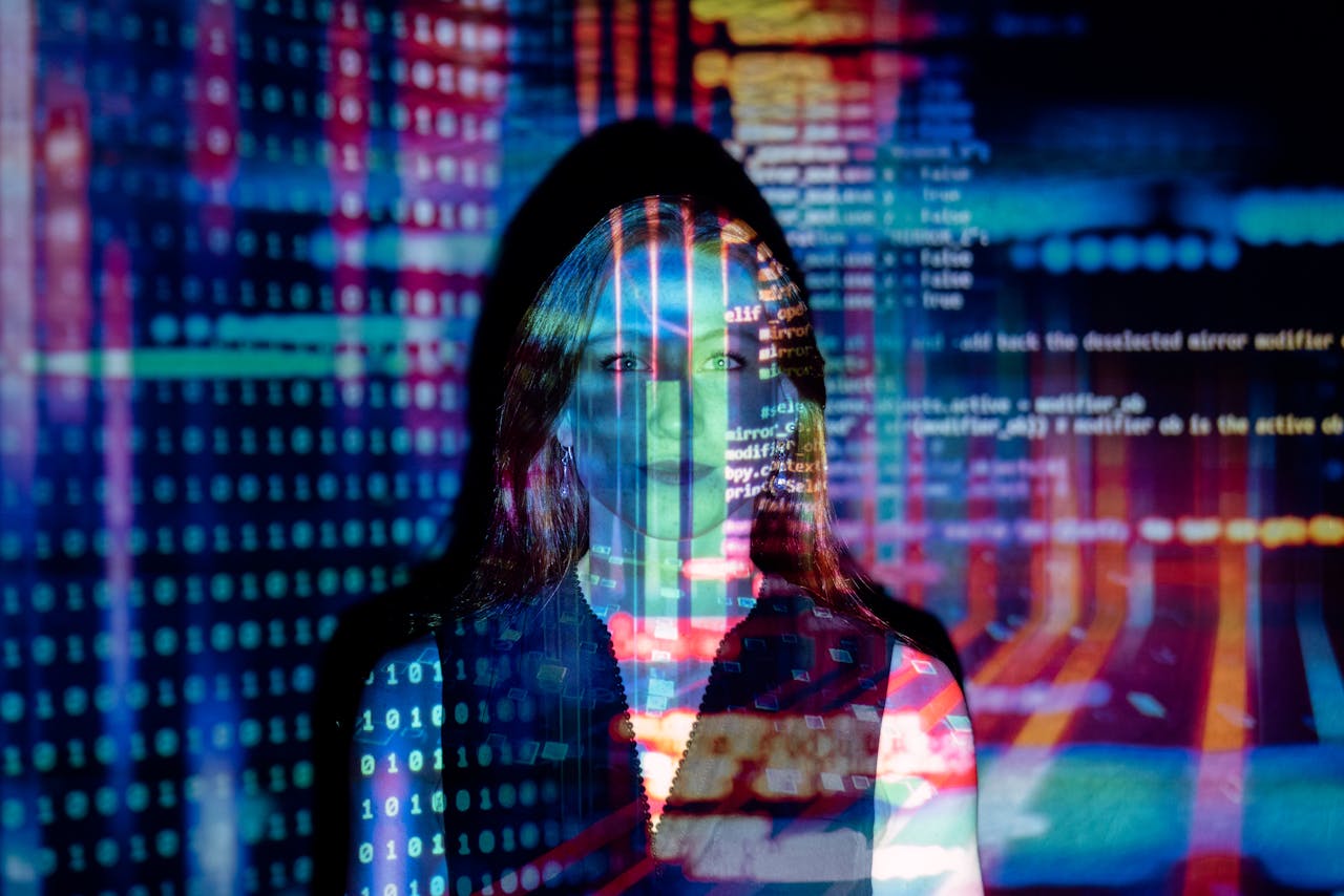 woman standing in the reflection of a computer screen