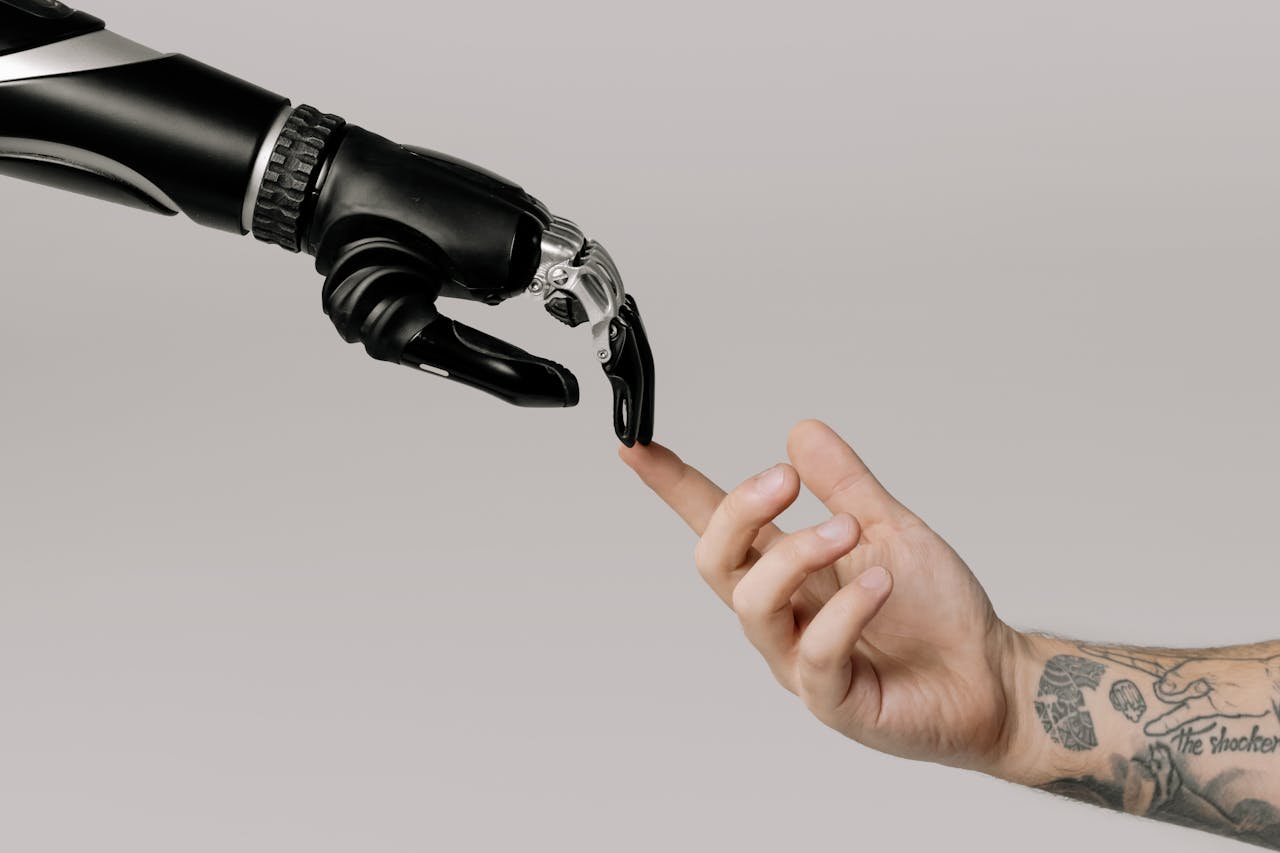 image of man hand touching the hand of a robot