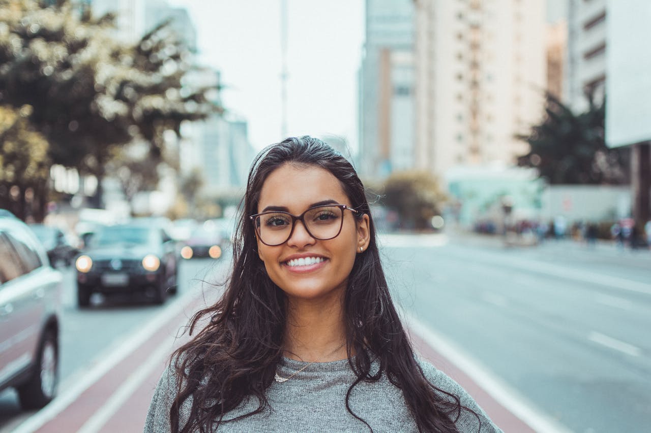 image of young white woman wearing glasses and smiling